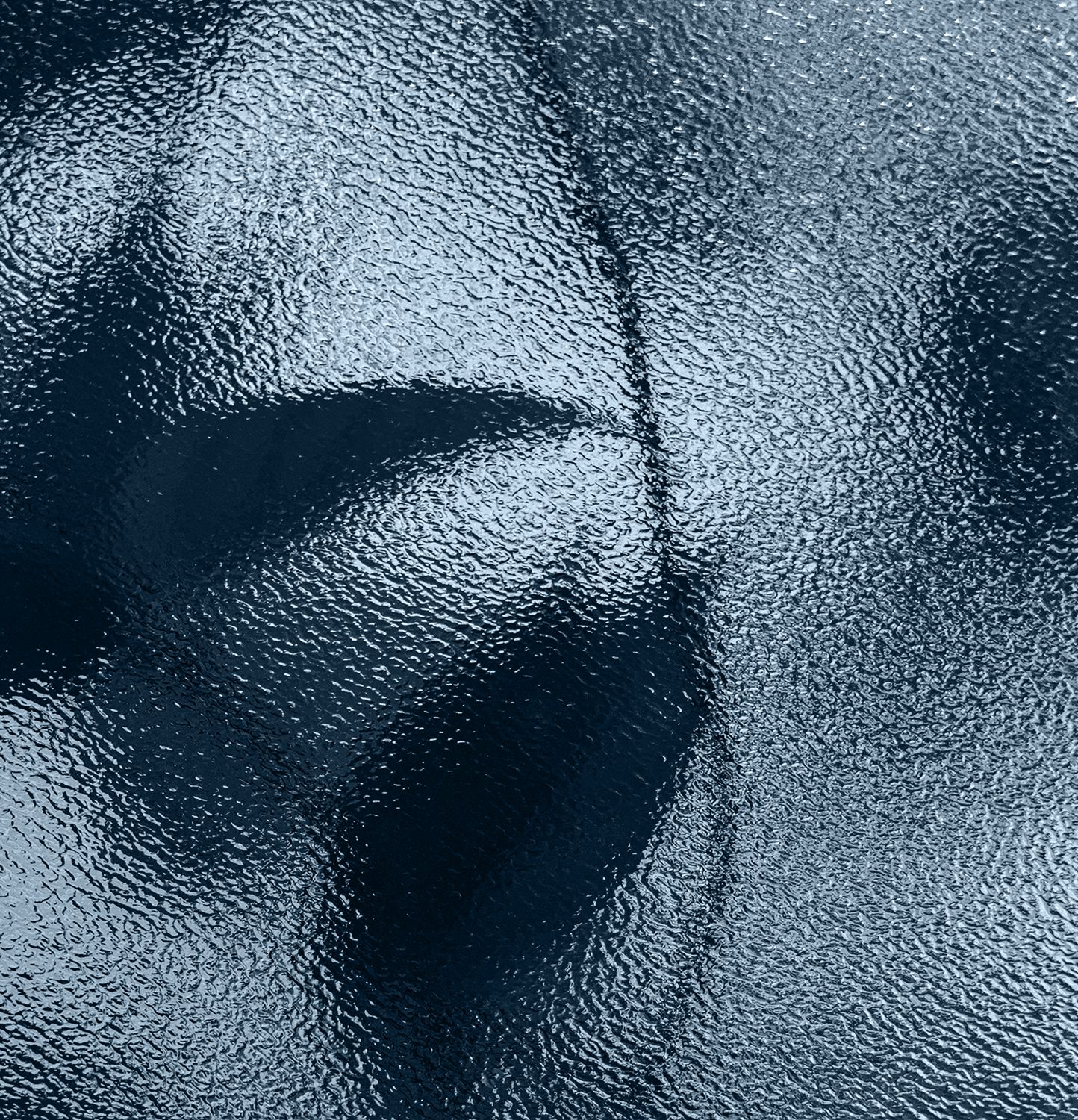 Textured blue surface with abstract shadows.