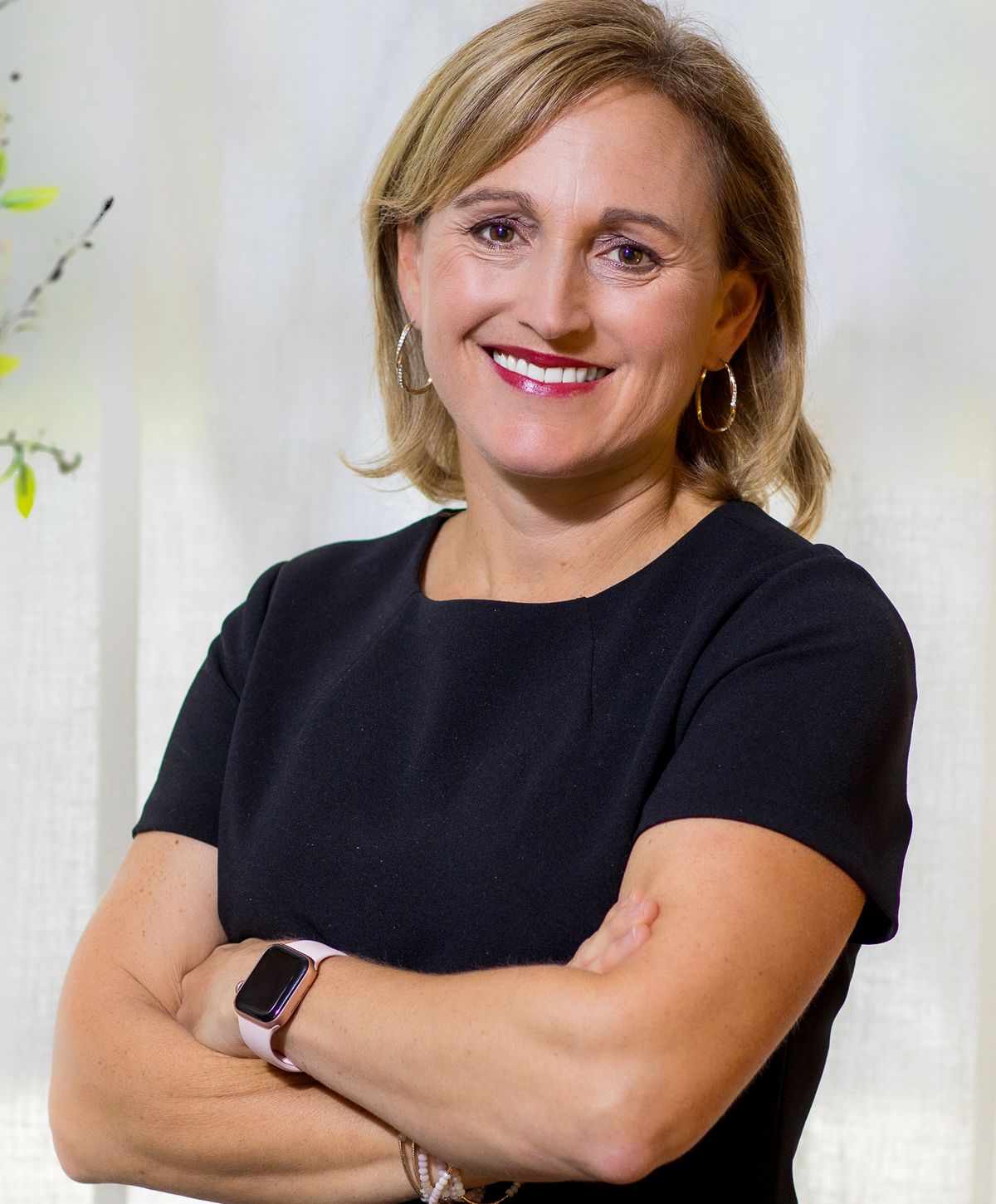 Person in casual indoor outfit by a couch.