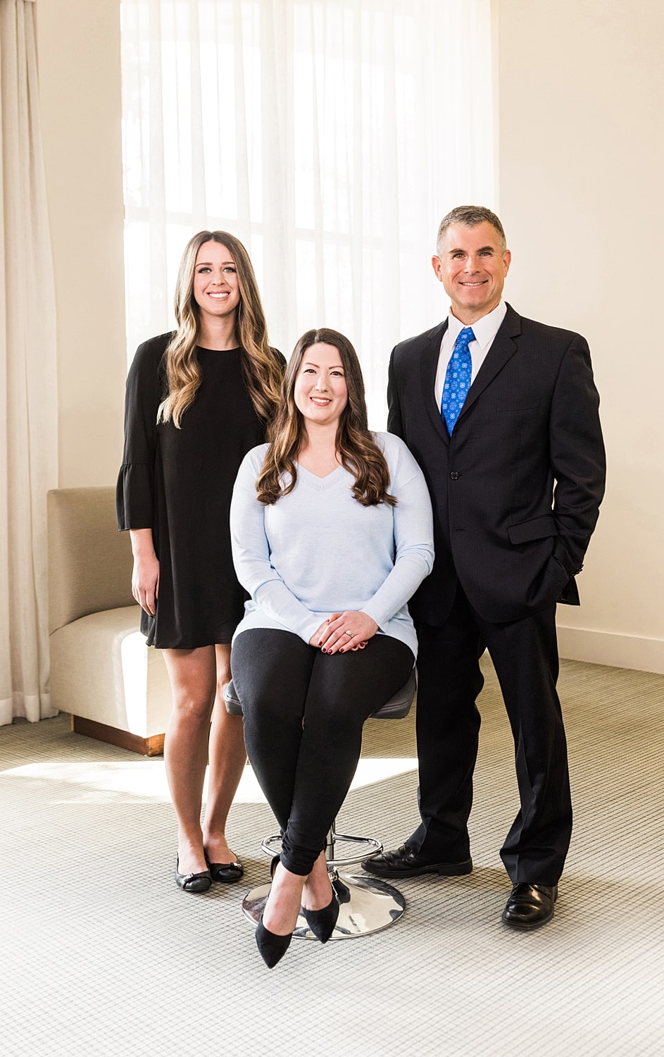 Professional group portrait in an indoor setting.