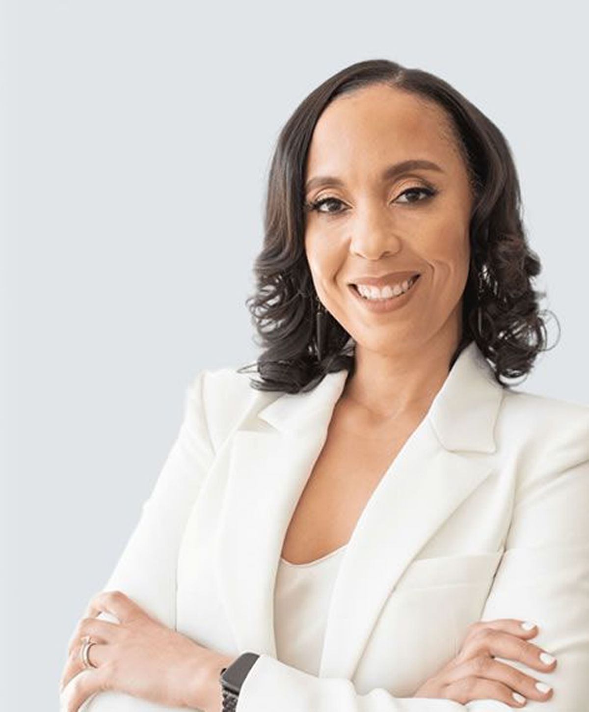 Professional woman smiling in a white blazer.
