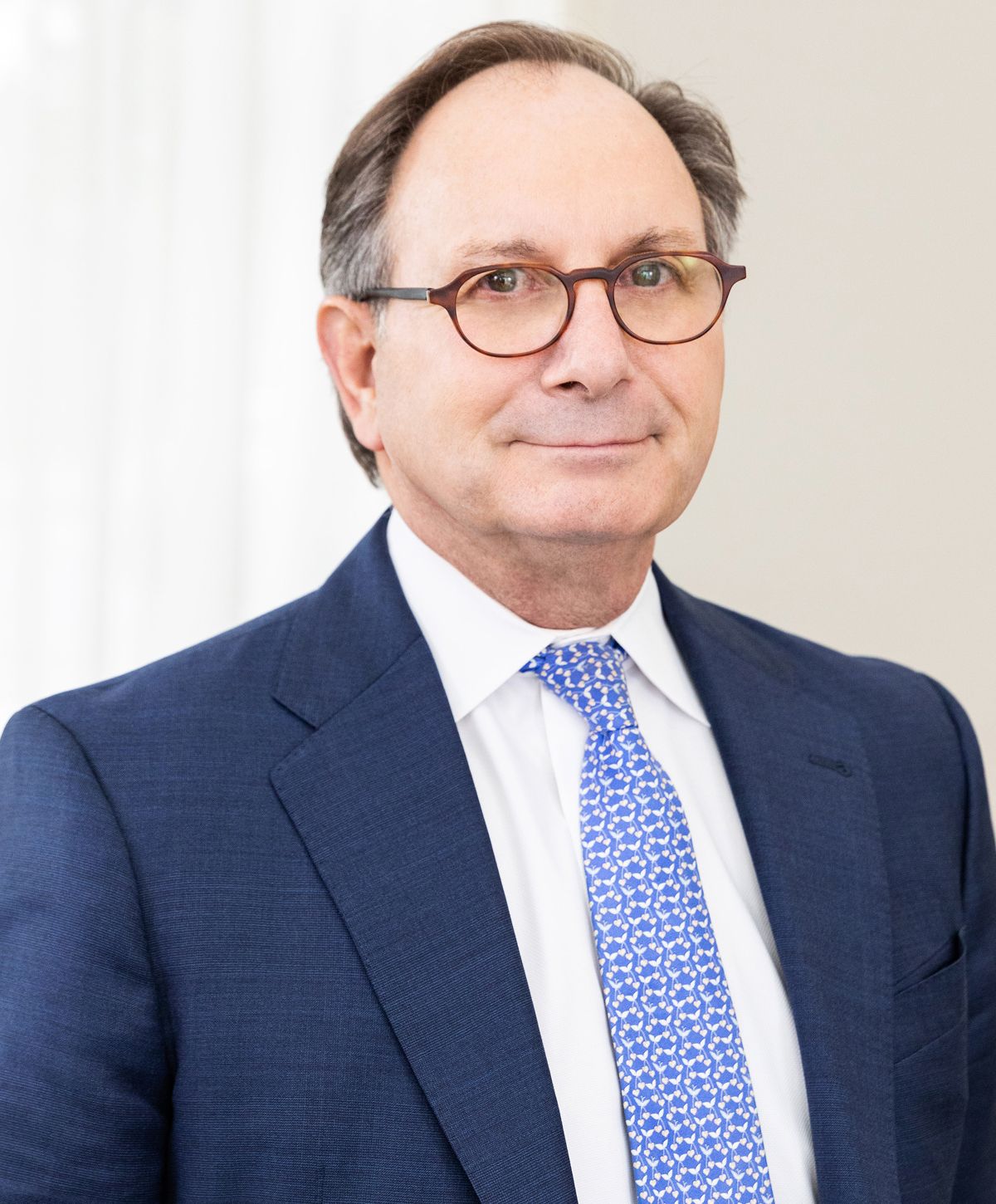 Model in gray jeans sitting on the floor.