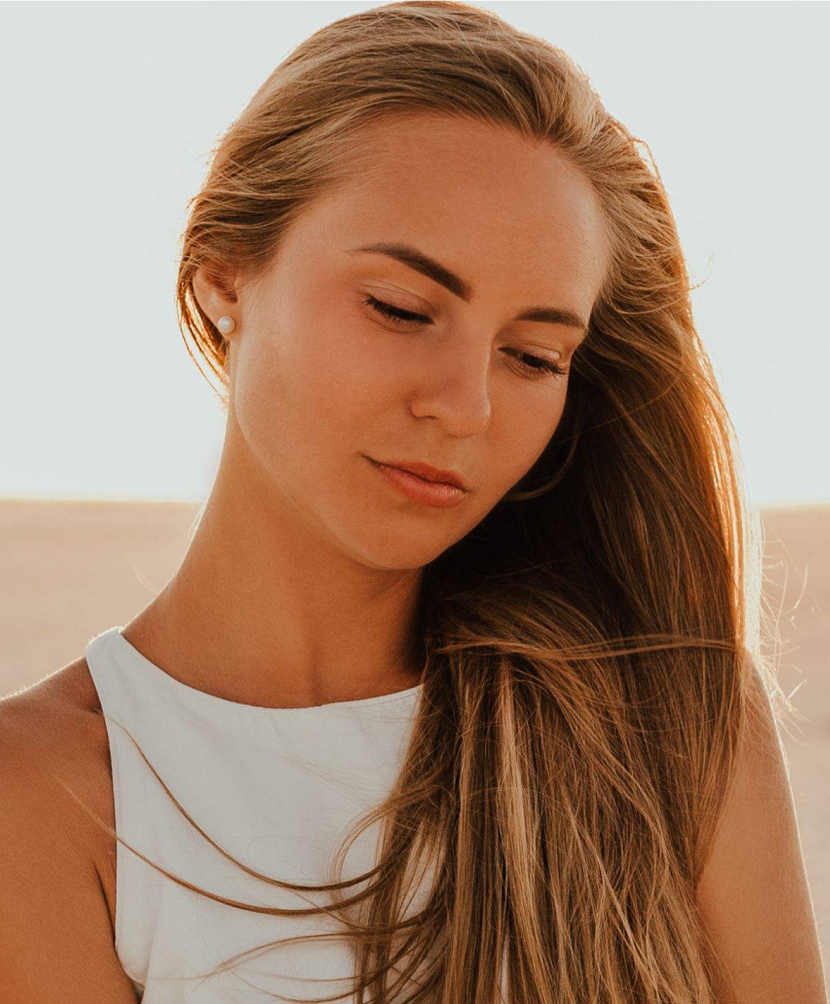 Woman with long hair in soft sunlight.