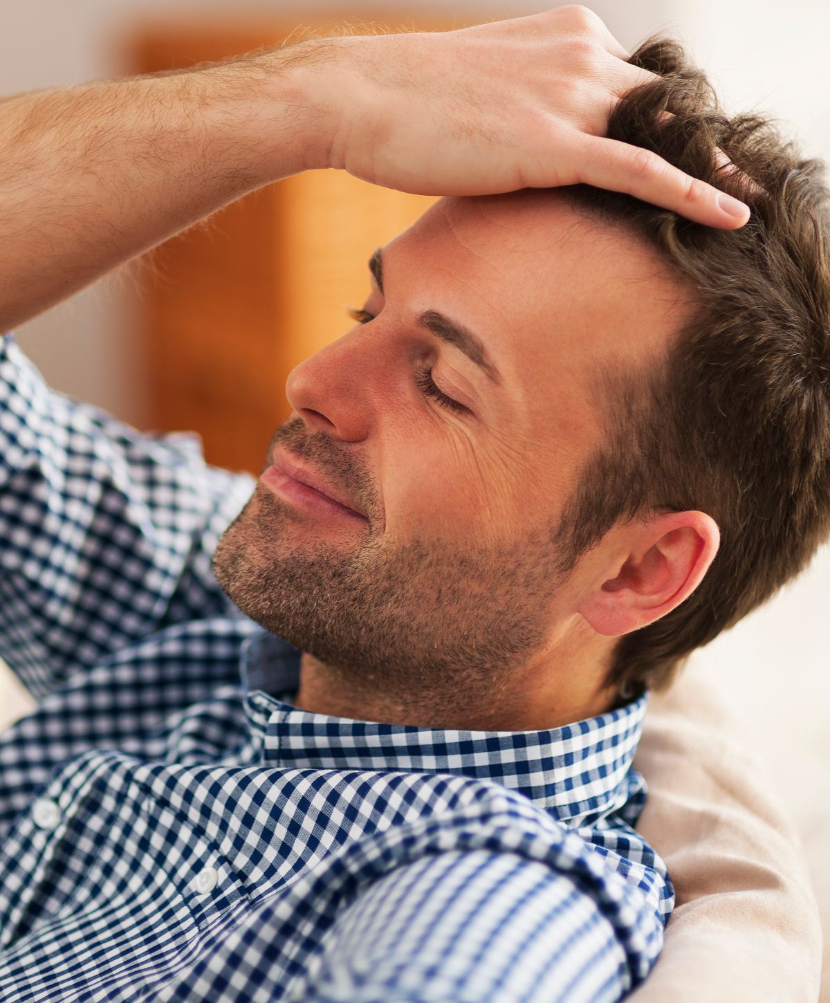 Man relaxing with a thoughtful expression.