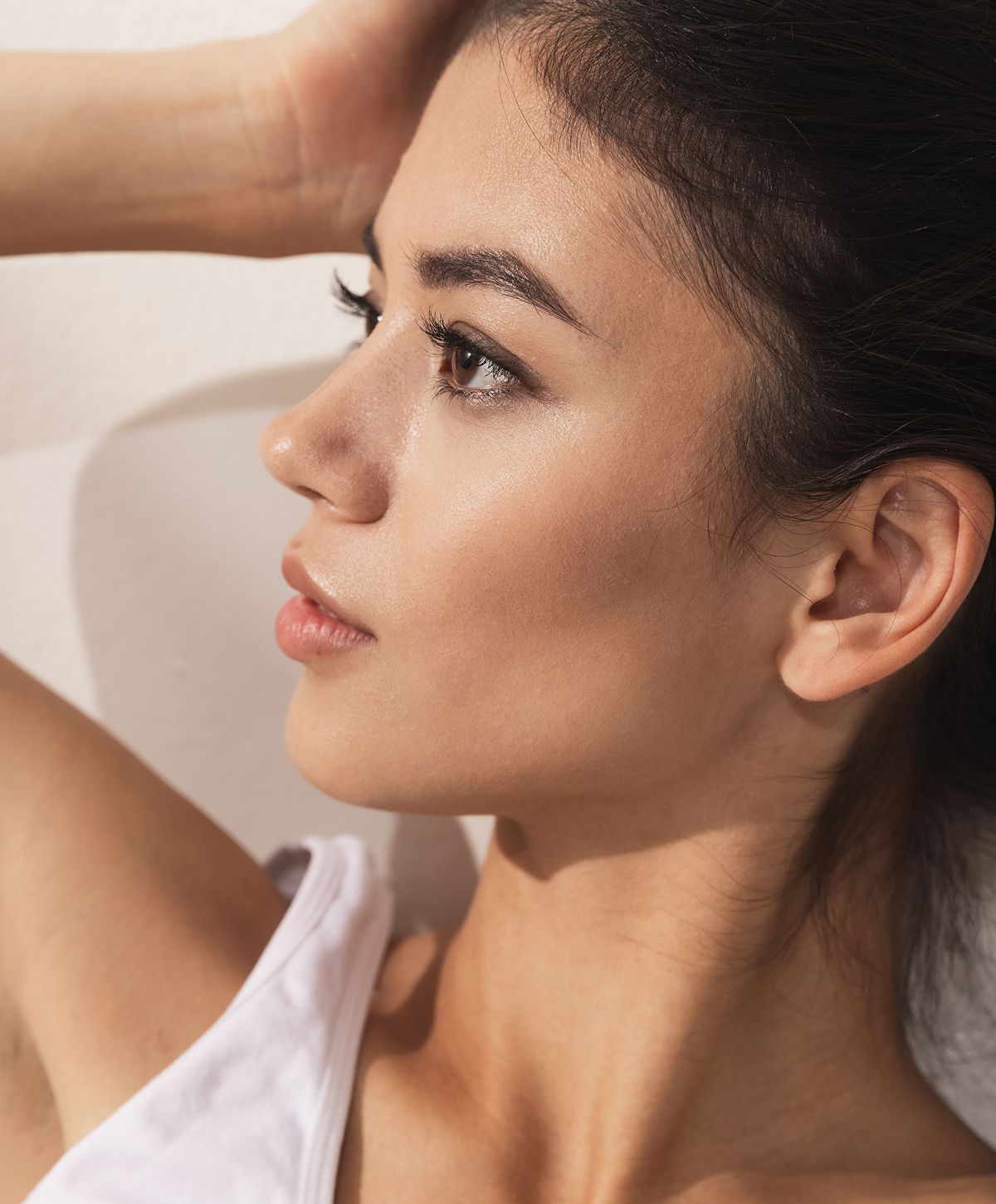Profile portrait of a woman with natural makeup.