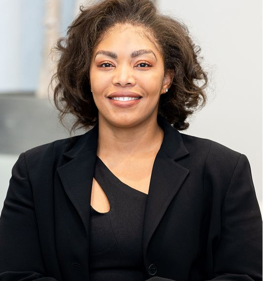 Smiling woman in professional attire, portrait.