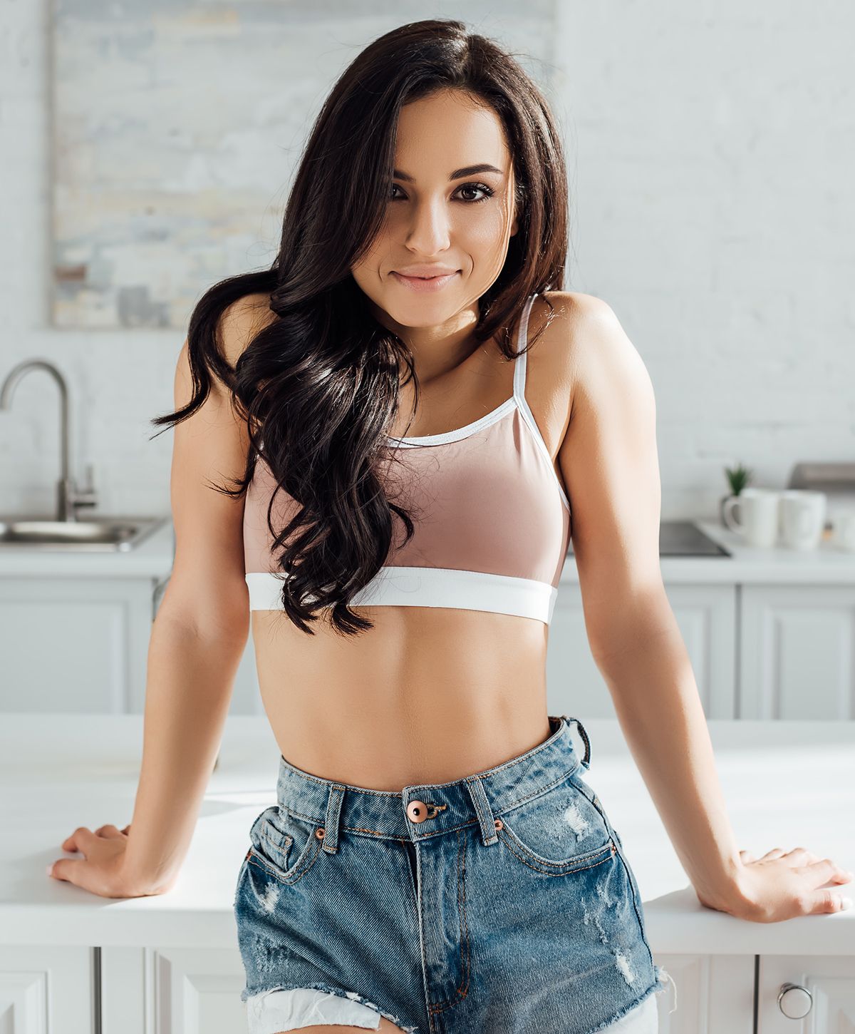 Woman in athletic wear by a window.