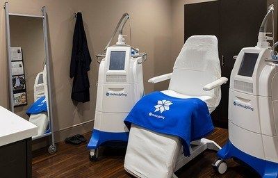 Medical treatment room with equipment and chair.