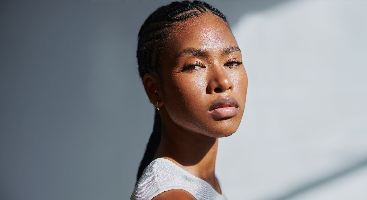 Close-up portrait of a woman with braids.