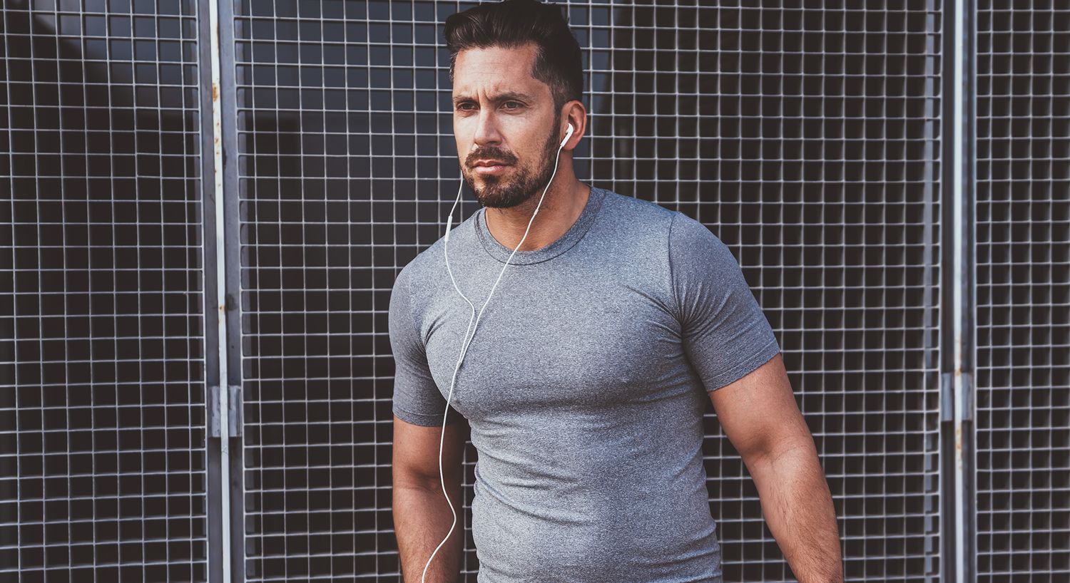 Man in fitness attire listening to music.